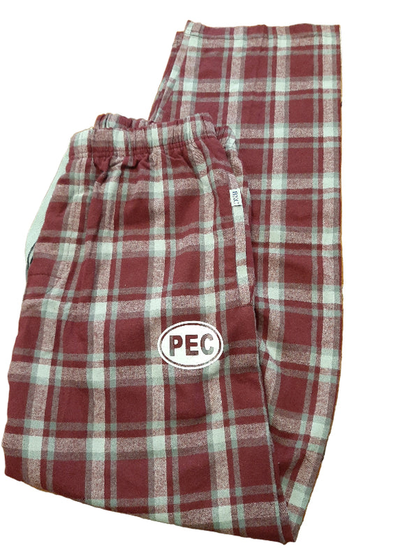 Red and white plaid pants with a logo on a wooden surface