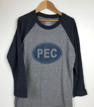 pec oval design in navy blue ink on navy blue sleeve and grey body baseball shirt prince edward county