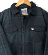 men's unisex plaid flannel quilted jacket with pec oval faux leather patch on side pocket prince edward county close up