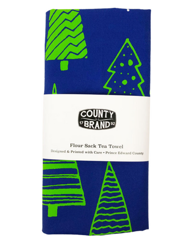 blue tea towel with green evergreen trees with county brand packaging prince edward county christmas