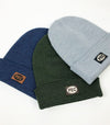 group of three merino wool made in canada beanie toques with pec oval faux leather patch prince edward county