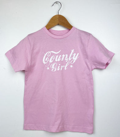 pink youth t-shirt with white county girl text design from prince edward county